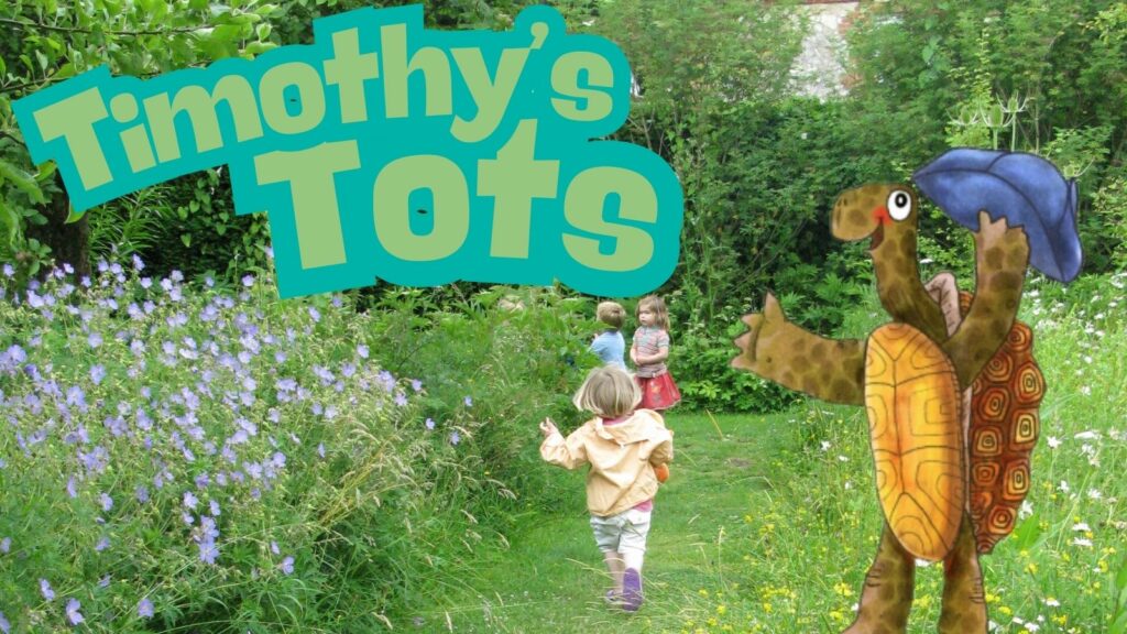 Timothy Tortoise and children exploring the gardens